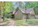 An attractive house surrounded by greenery featuring a brick walkway and attached garage at 100 Ashland Trl, Tyrone, GA 30290