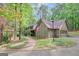 A charming home with an American flag, mature landscaping, and brick walkway and driveway at 100 Ashland Trl, Tyrone, GA 30290