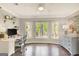Well-lit home office with desk, storage, and large window views of greenery at 100 Ashland Trl, Tyrone, GA 30290
