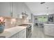 Bright kitchen with stainless steel oven, grey backsplash, and an open view to the dining area at 100 Ashland Trl, Tyrone, GA 30290