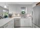 Bright kitchen features white cabinets, stainless steel appliances and stylish tile backsplash at 100 Ashland Trl, Tyrone, GA 30290