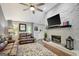 Bright living room features stone fireplace, ceiling fan, and exterior views at 100 Ashland Trl, Tyrone, GA 30290