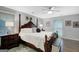 The main bedroom features a four-poster bed, bedside tables, and a ceiling fan providing a comfortable retreat at 100 Ashland Trl, Tyrone, GA 30290