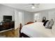 View of the main bedroom featuring a four-poster bed, wood flooring and an ensuite bathroom at 100 Ashland Trl, Tyrone, GA 30290