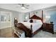 Spacious main bedroom featuring a four-poster bed, ceiling fan and access to the ensuite bathroom at 100 Ashland Trl, Tyrone, GA 30290