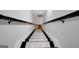 Stylish staircase with patterned runner and wooden handrails leads to the upper level at 100 Ashland Trl, Tyrone, GA 30290