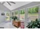 Light-filled sunroom with multiple windows offering peaceful backyard views at 100 Ashland Trl, Tyrone, GA 30290