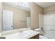 Bright bathroom featuring a large mirror, single sink vanity, tub and shower combination, and a neutral color scheme at 110 Tamarack Trl, Mcdonough, GA 30252
