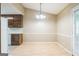 Light filled dining area with wood flooring and a modern light fixture at 110 Tamarack Trl, Mcdonough, GA 30252