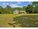 Charming single-story home with well-maintained lawn, mature trees, and a partial stone facade at 110 Tamarack Trl, Mcdonough, GA 30252