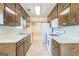 Well-lit kitchen featuring a stove and oven, and double stainless steel sink at 110 Tamarack Trl, Mcdonough, GA 30252