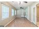Spacious living area with tile floors, built in shelving, and multiple windows at 110 Tamarack Trl, Mcdonough, GA 30252