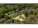Aerial view of property highlighting large lot, pond, and mature trees at 325 Elderberry Trl, Fayetteville, GA 30214