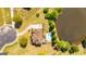 Aerial view of the home, long driveway, landscaping, and pool close to the lake at 325 Elderberry Trl, Fayetteville, GA 30214