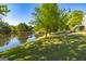 Expansive backyard with lake view, mature trees and lush lawn create a tranquil setting at 325 Elderberry Trl, Fayetteville, GA 30214