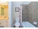 Compact bathroom featuring tiled walls, a bathtub with shower, and a single sink vanity at 325 Elderberry Trl, Fayetteville, GA 30214