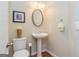 Cozy half-bath with a pedestal sink and neutral decor at 325 Elderberry Trl, Fayetteville, GA 30214