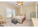 A cozy bedroom featuring a four-poster bed, plush carpeting, and a ceiling fan at 325 Elderberry Trl, Fayetteville, GA 30214