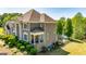 Lovely brick home showcasing a backyard pool, lush landscaping, and an outdoor seating area at 325 Elderberry Trl, Fayetteville, GA 30214
