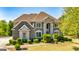 Beautiful two-story brick home with manicured landscaping and a well-maintained front lawn at 325 Elderberry Trl, Fayetteville, GA 30214