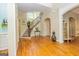 Welcoming foyer showcasing hardwood floors and a staircase with iron spindles at 325 Elderberry Trl, Fayetteville, GA 30214