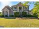 Beautiful brick home with manicured lawn, mature landscaping and elegant entrance at 325 Elderberry Trl, Fayetteville, GA 30214