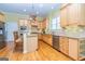 Well-lit kitchen with stainless steel appliances, island, and granite countertops at 325 Elderberry Trl, Fayetteville, GA 30214