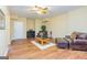 Finished basement area featuring hardwood floors, comfortable seating, and a faux fireplace at 325 Elderberry Trl, Fayetteville, GA 30214