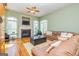 Comfortable living room with fireplace, hardwood floors and natural light at 325 Elderberry Trl, Fayetteville, GA 30214