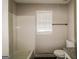 This bathroom offers a window and a tub and shower at 6024 S Deshon Ct, Lithonia, GA 30058