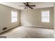 Cozy bedroom with neutral walls, carpet floors, and two windows providing natural light at 6024 S Deshon Ct, Lithonia, GA 30058