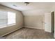 This bedroom features neutral carpet, paint, and a large window at 6024 S Deshon Ct, Lithonia, GA 30058