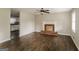 Inviting living room with hardwood floors, decorative fireplace, and a glimpse into the adjacent kitchen at 6024 S Deshon Ct, Lithonia, GA 30058