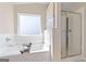 A bright bathroom with a separate tub, shower, and window at 284 Villa Grande Dr, Locust Grove, GA 30248