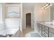 Bathroom featuring gray cabinets, granite countertops, and separate tub and walk-in shower at 284 Villa Grande Dr, Locust Grove, GA 30248