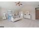Bright bedroom with a plush bed, white dresser, and comfortable seating at 284 Villa Grande Dr, Locust Grove, GA 30248