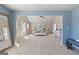 Open bedroom featuring neutral decor, a blue accent wall, and a home gym at 284 Villa Grande Dr, Locust Grove, GA 30248
