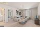 Cozy bonus room features a sectional sofa, striped ottomans, neutral decor, and a view into an adjacent bedroom at 284 Villa Grande Dr, Locust Grove, GA 30248