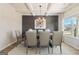 Elegant dining room featuring wainscoting, coffered ceiling, modern chandelier, and large windows at 284 Villa Grande Dr, Locust Grove, GA 30248