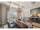 Cozy dining room with natural light, a modern chandelier, decor, and comfortable seating at 284 Villa Grande Dr, Locust Grove, GA 30248