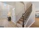 Inviting entryway featuring a staircase, hardwood floors, and natural light at 284 Villa Grande Dr, Locust Grove, GA 30248