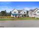 Charming two-story home with manicured lawn and inviting curb appeal on a sunny day at 284 Villa Grande Dr, Locust Grove, GA 30248