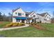 Inviting two-story home with green grass, shrubs, and a peaceful neighborhood view at 284 Villa Grande Dr, Locust Grove, GA 30248