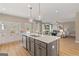 Open-concept kitchen features a large island, pendant lighting and stainless steel appliances, connecting seamlessly to the living area at 284 Villa Grande Dr, Locust Grove, GA 30248