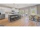 Well-lit kitchen with a large island, stainless steel appliances, and an adjacent dining area at 284 Villa Grande Dr, Locust Grove, GA 30248