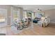 Open living space features a fireplace, hardwood floors, a dining area, and large windows offering natural light at 284 Villa Grande Dr, Locust Grove, GA 30248