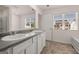 Bathroom with double sinks, tile floor and view of the neighborhood at 12040 Conrad Cir, Hampton, GA 30228