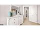 Bedroom featuring dresser with mirror and view into hallway at 12040 Conrad Cir, Hampton, GA 30228