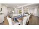 Open-concept dining area showcasing hardwood floors, neutral walls, and access to both kitchen and living room at 12040 Conrad Cir, Hampton, GA 30228