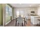 Bright dining area with modern table, chairs, and decor, located adjacent to kitchen and overlooking backyard at 12040 Conrad Cir, Hampton, GA 30228